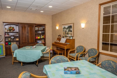 STM Interiors room with piano and tables