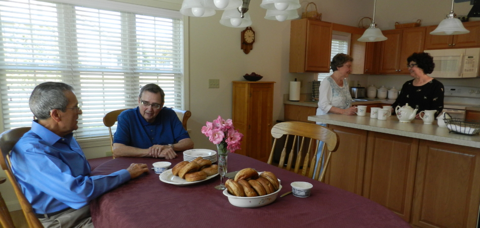 Two couples visiting in the kitchen